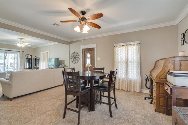 dining area with visible vents, a ceiling fan, light carpet, and ornamental molding