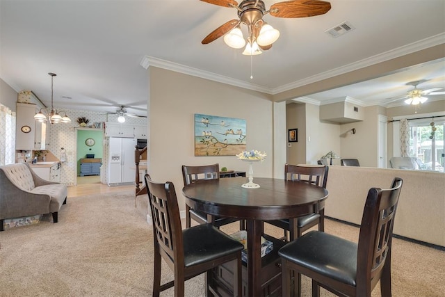 dining space with crown molding and ceiling fan