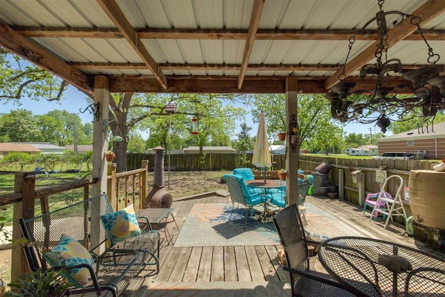 deck with a fenced backyard and outdoor dining area