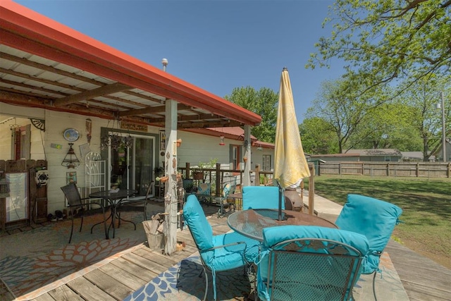 deck with fence, a yard, and outdoor dining space