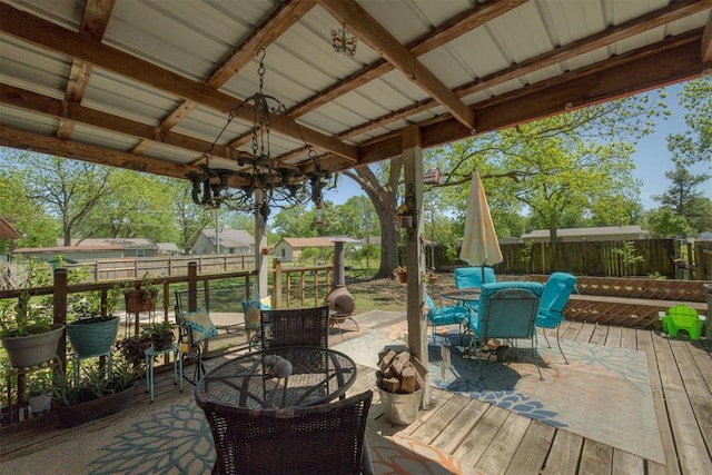 wooden terrace featuring a fenced backyard and outdoor dining space