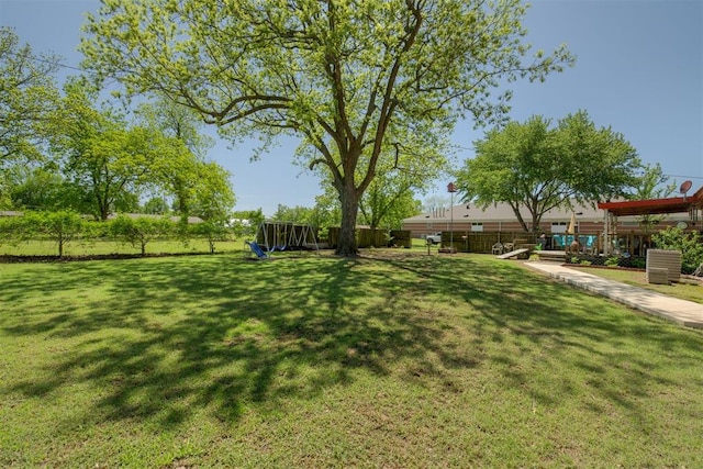 view of yard featuring a playground and fence