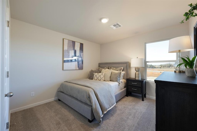 bedroom featuring baseboards, light colored carpet, and visible vents