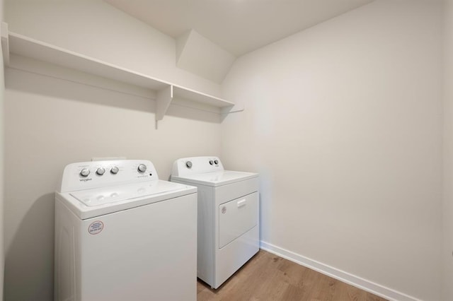 laundry room with independent washer and dryer, laundry area, baseboards, and light wood finished floors