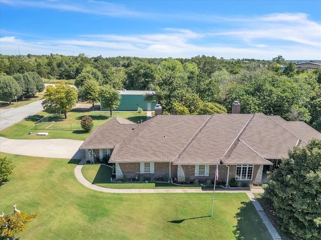 1008 Bavarian Dr, Edmond, OK 73034 - view of front of home featuring a chimney, a front yard, and brick siding