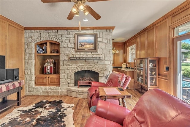 1008 Bavarian Dr, Edmond, OK 73034 - living area with ceiling fan, wood finished floors, a fireplace, and built in features