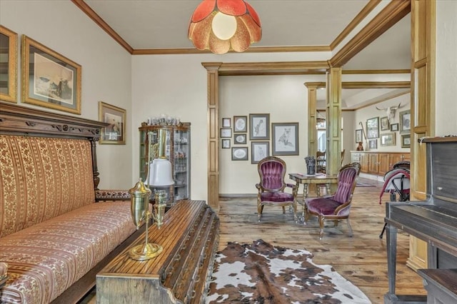 1008 Bavarian Dr, Edmond, OK 73034 - living room featuring ornamental molding, decorative columns, and wood finished floors