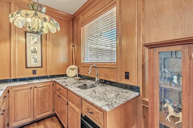 1008 Bavarian Dr, Edmond, OK 73034 - kitchen with light stone counters, light wood finished floors, and decorative light fixtures
