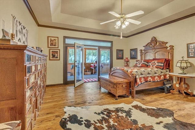 1008 Bavarian Dr, Edmond, OK 73034 - bedroom with light wood-type flooring, access to exterior, a tray ceiling, ornamental molding, and a ceiling fan