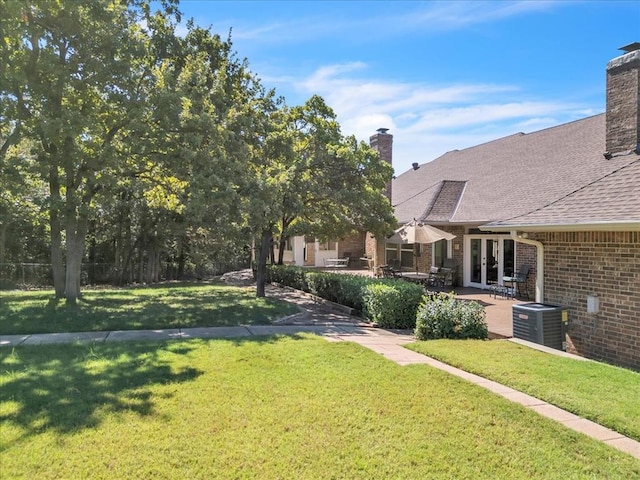 1008 Bavarian Dr, Edmond, OK 73034 - view of grassy yard with french doors and a patio