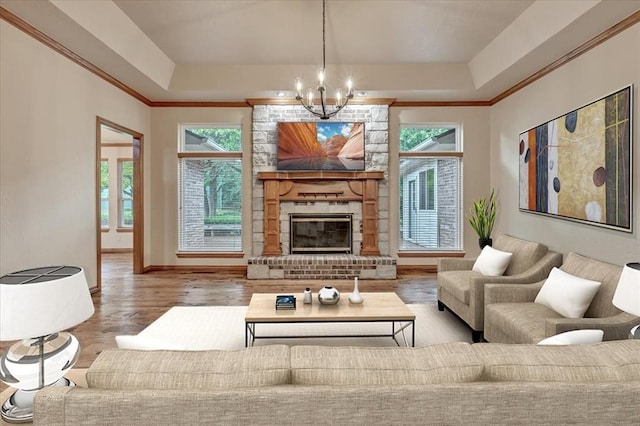 1008 Bavarian Dr, Edmond, OK 73034 - living area featuring a chandelier, a tray ceiling, healthy amount of natural light, and crown molding