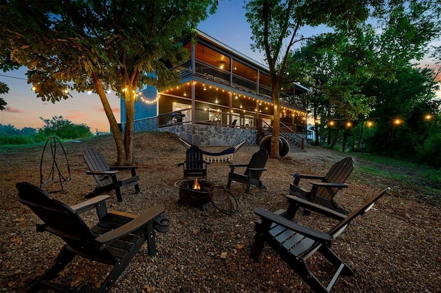 370 Stones River Ln, Broken Bow, OK 74728 - view of patio with an outdoor fire pit, stairs, and a balcony