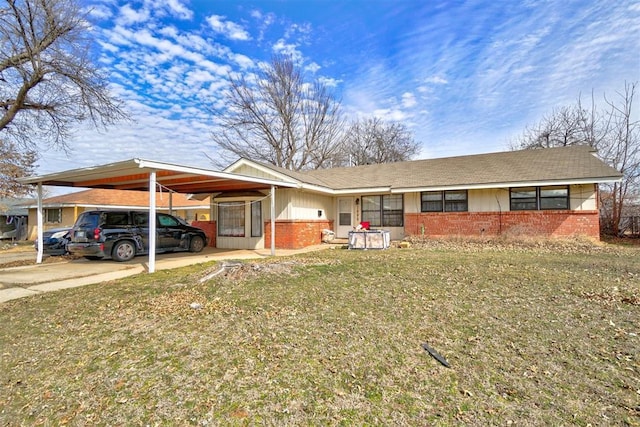 1008 Juniper Ave, Oklahoma City, OK 73130 - view of front of house featuring board and batten siding, an attached carport, driveway, and brick siding