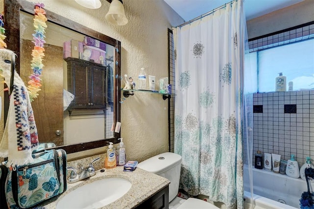 1008 Juniper Ave, Oklahoma City, OK 73130 - bathroom featuring toilet, a textured wall, shower / bath combo with shower curtain, and vanity