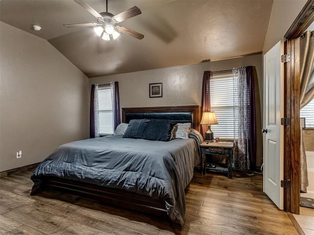 bedroom with wood finished floors, a ceiling fan, and lofted ceiling