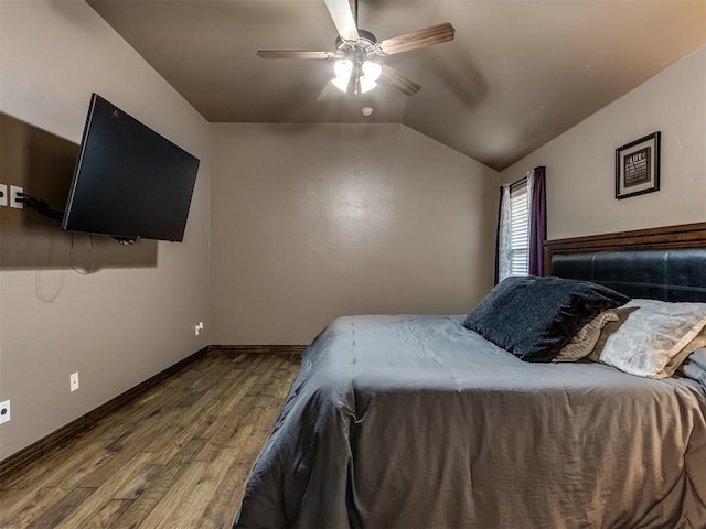 bedroom with baseboards, ceiling fan, wood finished floors, and lofted ceiling