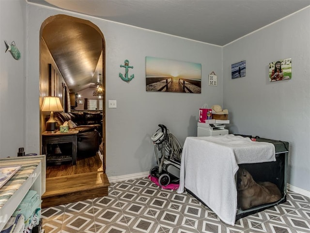 bedroom with arched walkways, baseboards, and tile patterned floors