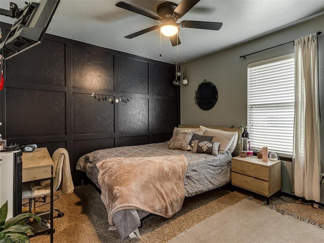 bedroom featuring carpet floors, ceiling fan, and multiple windows