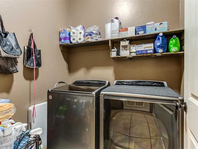 washroom featuring laundry area and washing machine and clothes dryer