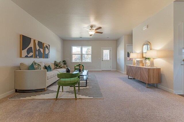 living room featuring carpet flooring, a ceiling fan, and baseboards