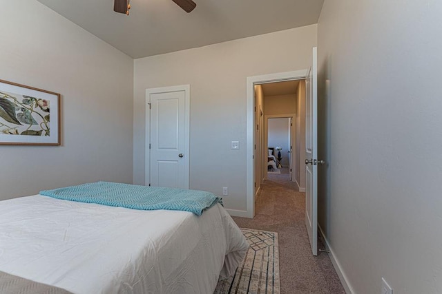 carpeted bedroom featuring a ceiling fan and baseboards