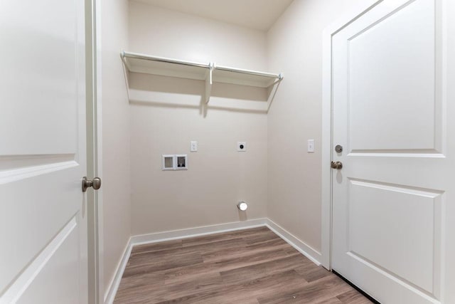 clothes washing area with hookup for an electric dryer, laundry area, wood finished floors, baseboards, and hookup for a washing machine