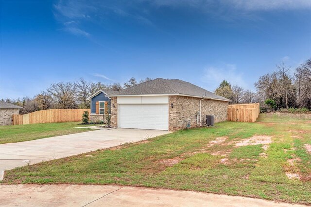 view of side of property with a lawn, brick siding, fence, concrete driveway, and an attached garage