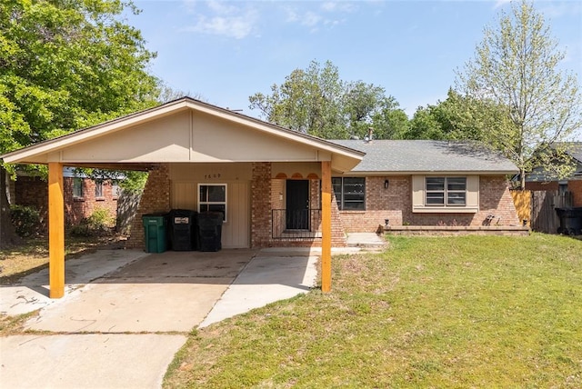 ranch-style house featuring concrete driveway, brick siding, a front yard, and a carport