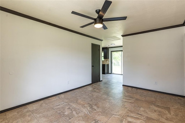 unfurnished room with baseboards, ornamental molding, stone finish floor, and a ceiling fan