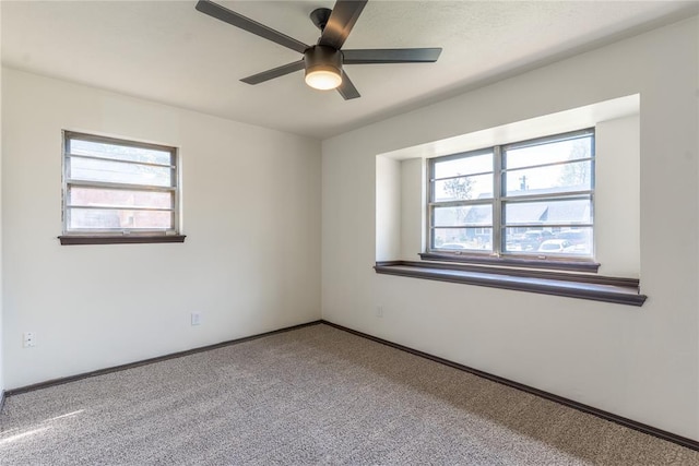 unfurnished room with baseboards, a ceiling fan, and carpet flooring