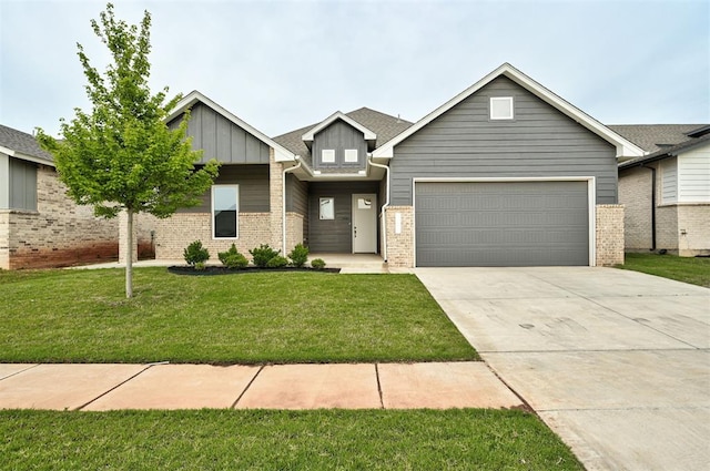 craftsman house with a garage, board and batten siding, driveway, a front yard, and brick siding