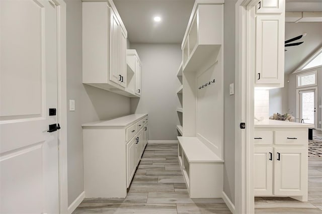 mudroom featuring baseboards, light wood finished floors, and recessed lighting
