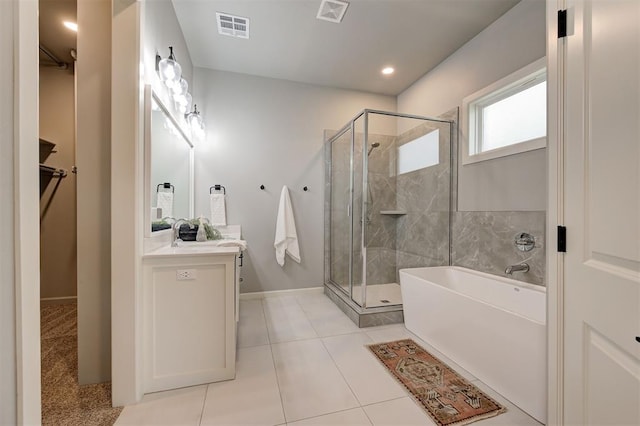 bathroom featuring a shower stall, vanity, a garden tub, baseboards, and recessed lighting