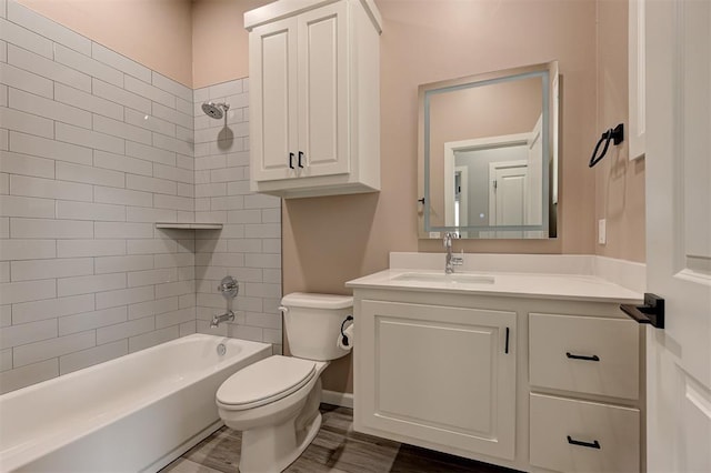 bathroom featuring toilet, washtub / shower combination, vanity, and wood finished floors