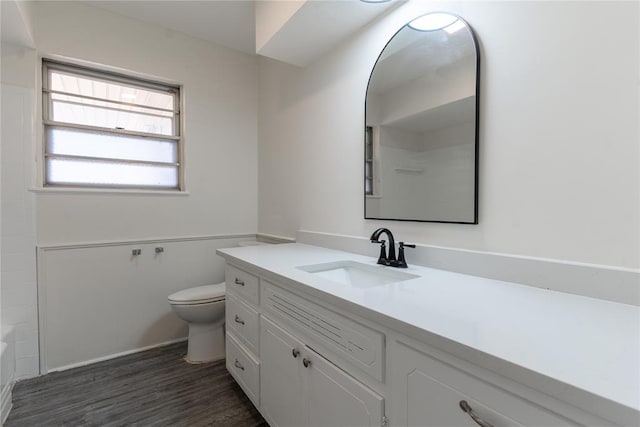 full bathroom featuring walk in shower, vanity, toilet, a tub, and wood finished floors