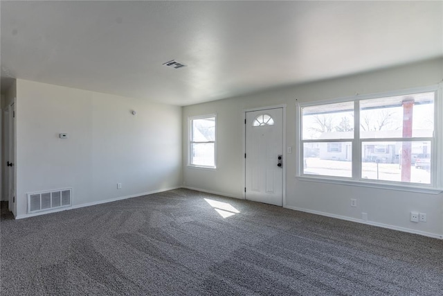 carpeted foyer featuring baseboards and visible vents