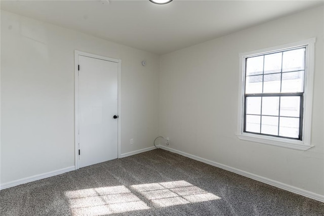 spare room with carpet flooring and baseboards