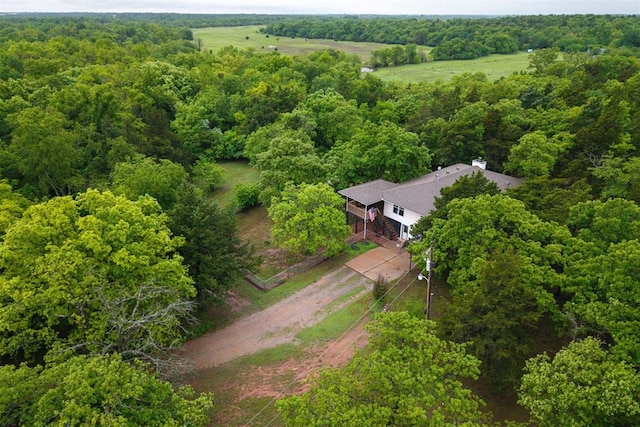 drone / aerial view featuring a view of trees