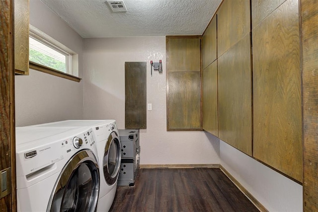 washroom featuring laundry area, visible vents, baseboards, separate washer and dryer, and dark wood-type flooring