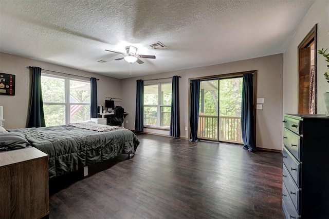 bedroom featuring visible vents, dark wood finished floors, multiple windows, and access to exterior