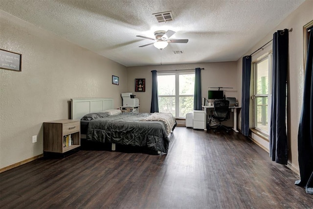 bedroom featuring a textured ceiling, visible vents, and wood finished floors