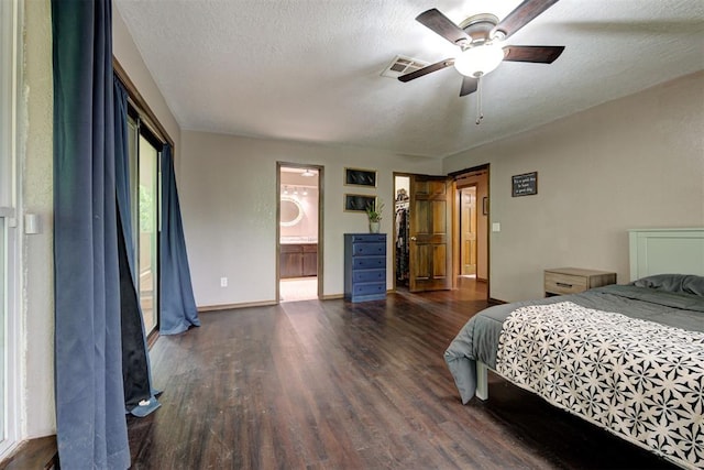 bedroom with visible vents, wood finished floors, baseboards, ceiling fan, and a textured ceiling
