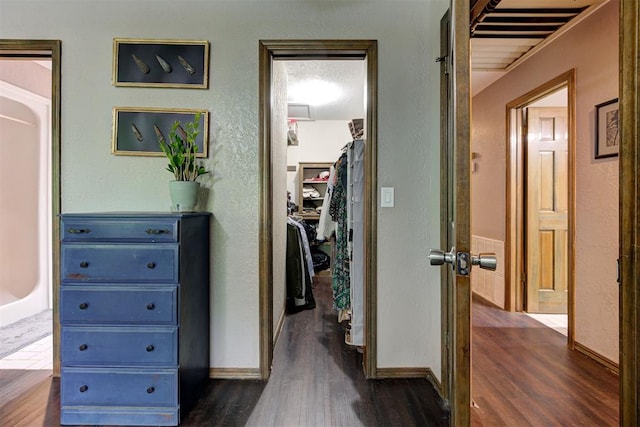hall featuring baseboards and dark wood-style floors