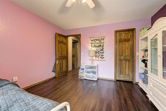 bedroom featuring a ceiling fan, baseboards, and wood finished floors