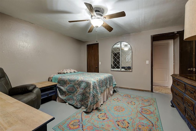 bedroom featuring a ceiling fan and concrete flooring
