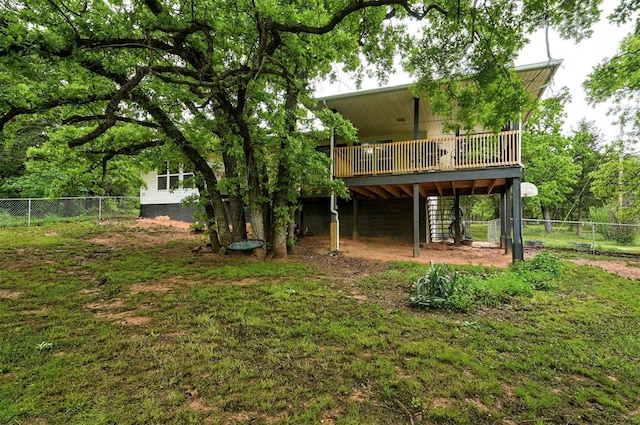 rear view of house with a yard, a wooden deck, stairs, and a fenced backyard