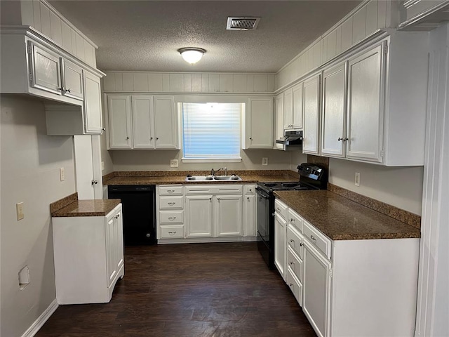924 N Bradley Ave, Oklahoma City, OK 73127 - kitchen with a sink, a textured ceiling, under cabinet range hood, visible vents, and black appliances