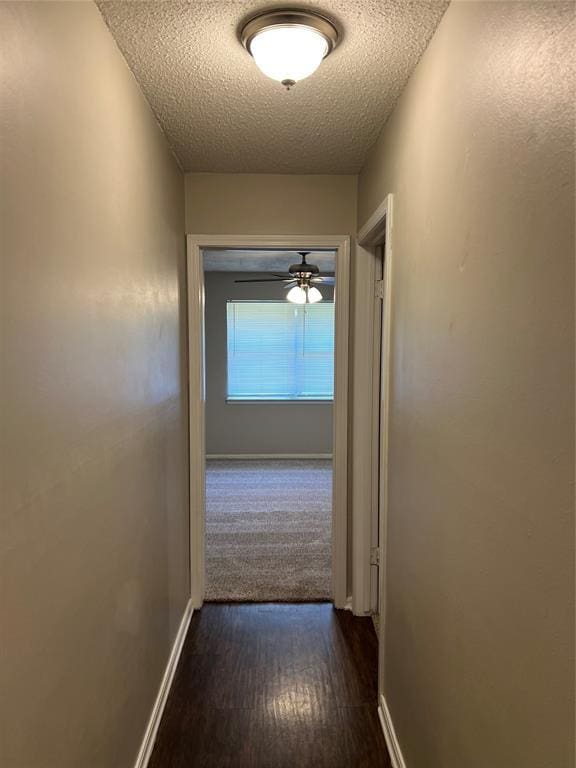 924 N Bradley Ave, Oklahoma City, OK 73127 - hall featuring baseboards, a textured ceiling, and dark wood-style floors