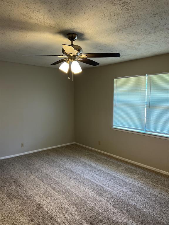 924 N Bradley Ave, Oklahoma City, OK 73127 - carpeted empty room featuring baseboards, ceiling fan, and a textured ceiling