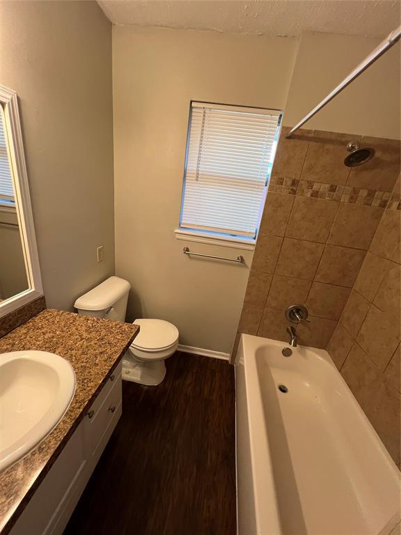 924 N Bradley Ave, Oklahoma City, OK 73127 - full bath with vanity, toilet, and wood finished floors